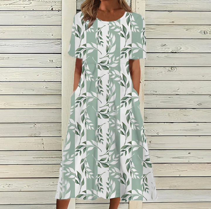 Robe midi femme printanière, motifs floraux délicats, coupe fluide pour un confort chic.