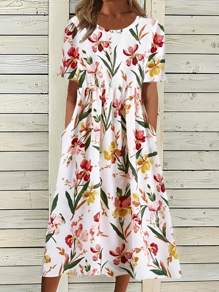 Mode féminine : robe midi fleurie aux motifs vibrants, style chic et fluide pour l'été.