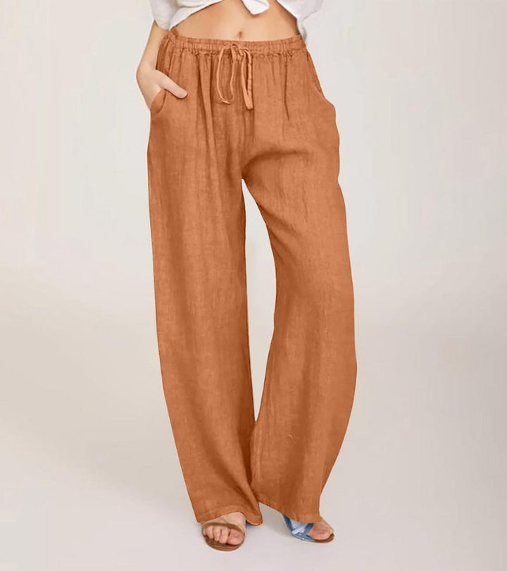 Pantalon large femme taille haute en lin, idéal pour un look estival décontracté et confortable.