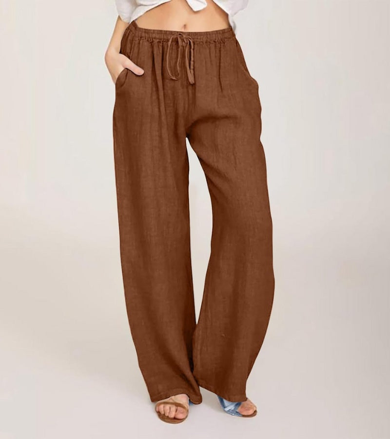 Dos d'un pantalon femme en lin, coupe large, taille haute, confortable pour un look estival décontracté.