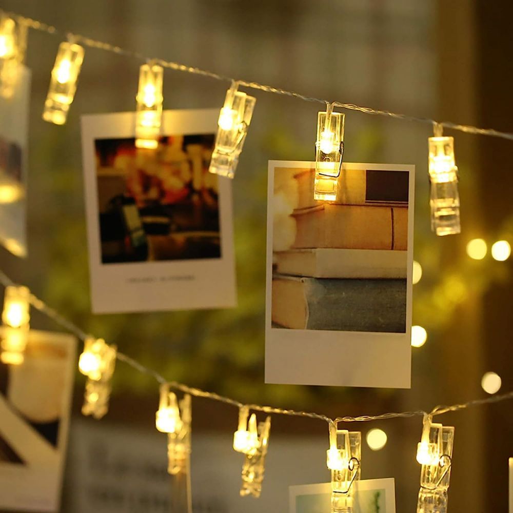 Guirlande lumineuse décorative LED avec clips pour photos, crée une ambiance douce et chaleureuse.