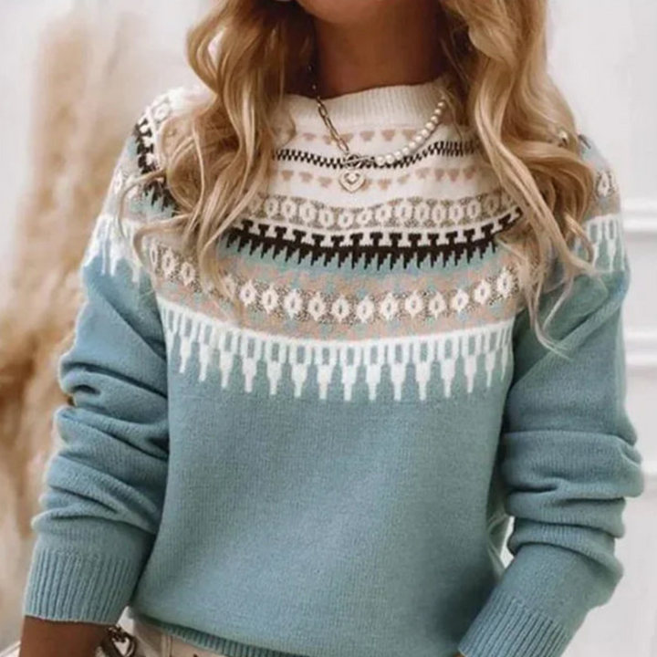 Pull femme d'hiver à motifs, coupe décontractée, col rond, manches longues. Vêtement chic et agréable à porter.
