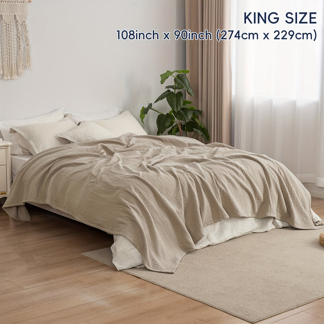 Plaid en coton vert clair Cloudsoft, polyvalent pour apporter douceur et style frais.