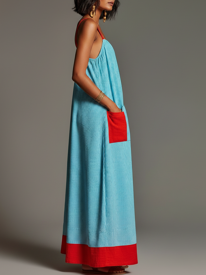 Élégante robe maxi femme fluide à rayures, avec de fines bretelles. Un essentiel pour un look estival chic.