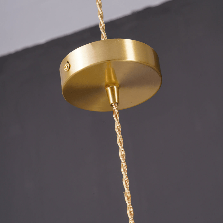 Suspension lumineuse design, ambiance tropicale, laiton et verre pour maison.
