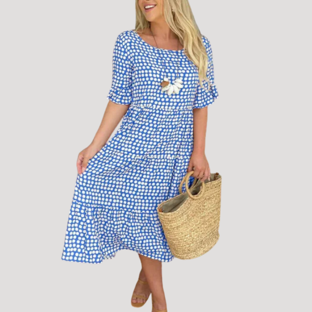 Robe femme midi à motifs pois, fluide et légère, idéale pour les journées chaudes, style décontracté et chic.
