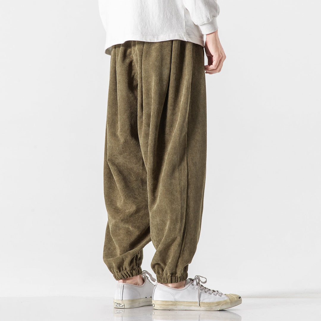 Détail du pantalon large homme, tissu confortable, style décontracté moderne, look automne/hiver.