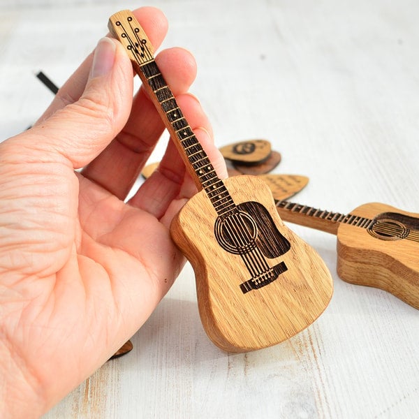 Support chêne sculpté pour médiators de guitare. Un rangement élégant et fonctionnel pour musiciens.