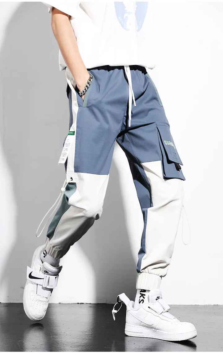 Pantalon cargo bicolore bleu homme, style urbain streetwear. Confortable, multi-poches, idéal printemps/été.