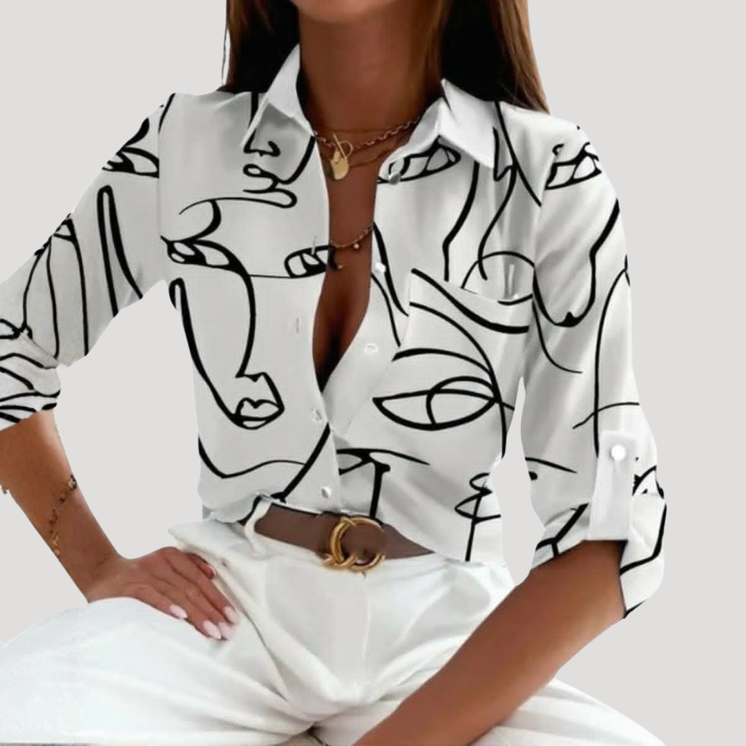 Blouse femme moderne à col chemise et motifs géométriques vifs, parfaite pour une tenue chic et versatile.