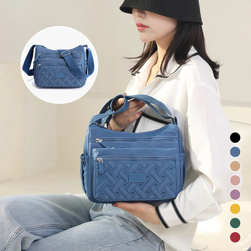 Sac femme fonctionnel avec multiples compartiments pour organisation optimale en voyage.