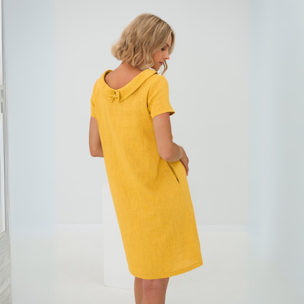 Confortable robe d'été fluide femme avec poches, tissu léger, parfaite pour la chaleur estivale.