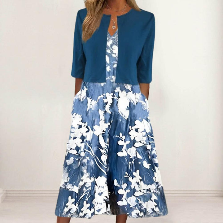 Gros plan sur robe midi fleurie élégante, motifs floraux vifs, tissu léger et fluide pour un confort estival.