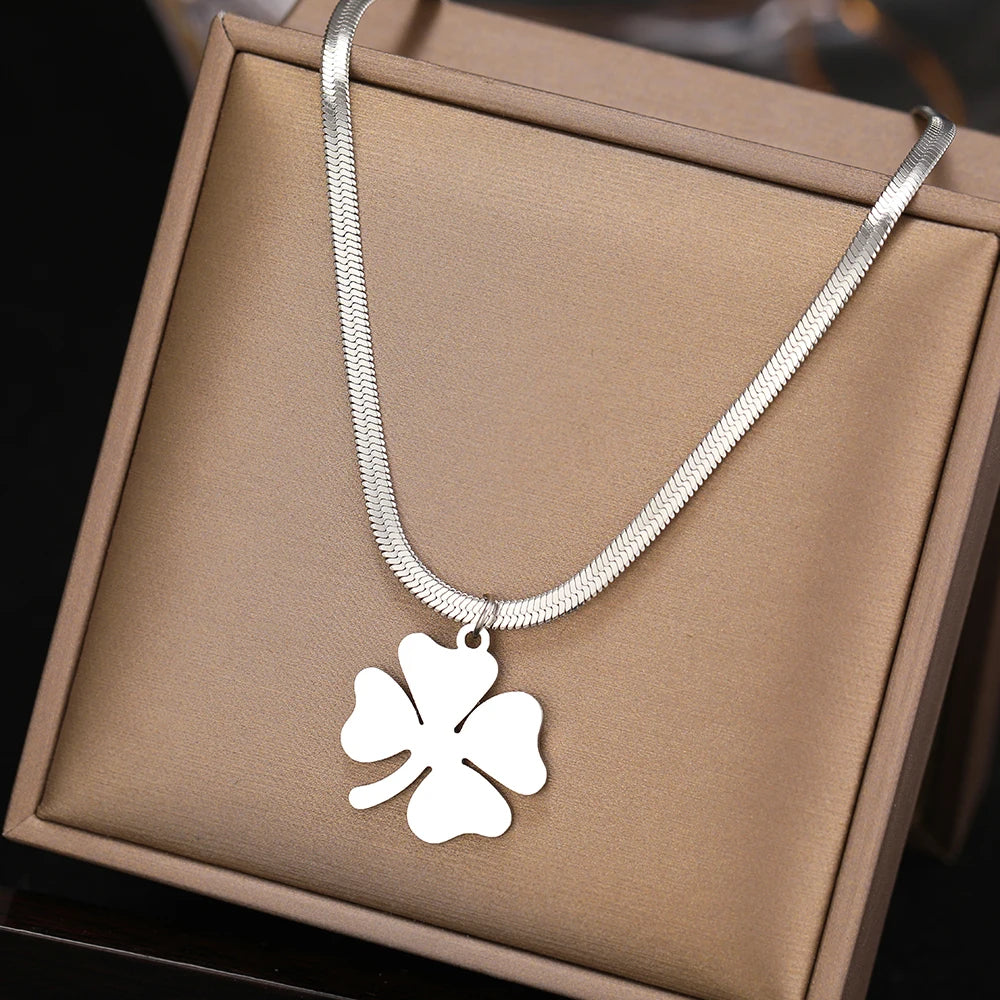 Gros plan sur pendentif trèfle élégant en acier inoxydable. Collier pour femmes, style chic et moderne.