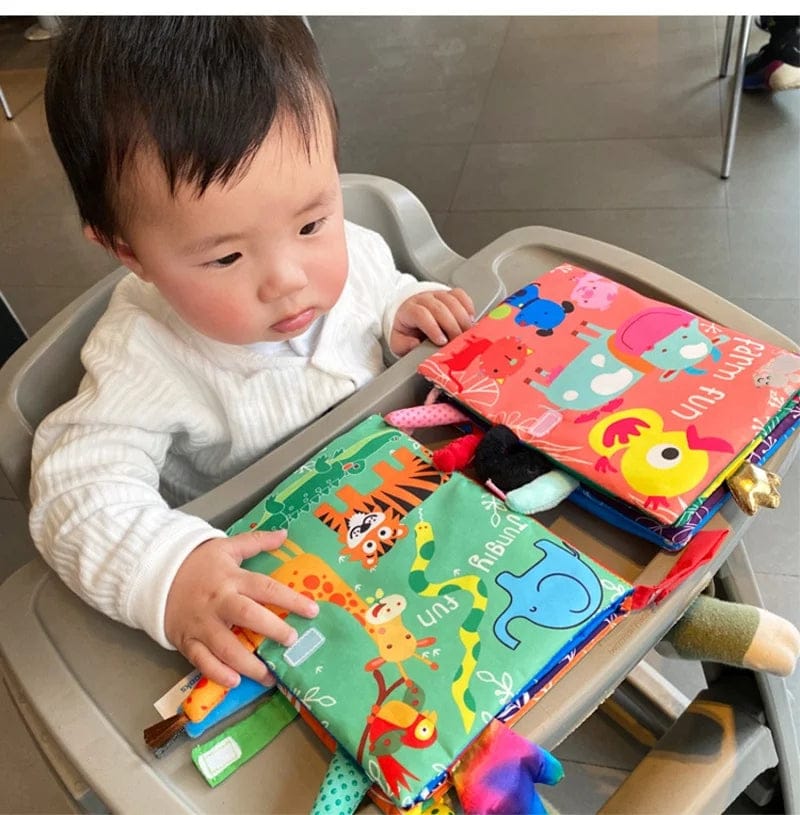 Livre d'éveil développement enfant, jouet sensoriel interactif avec animaux et textures variées pour bébé.