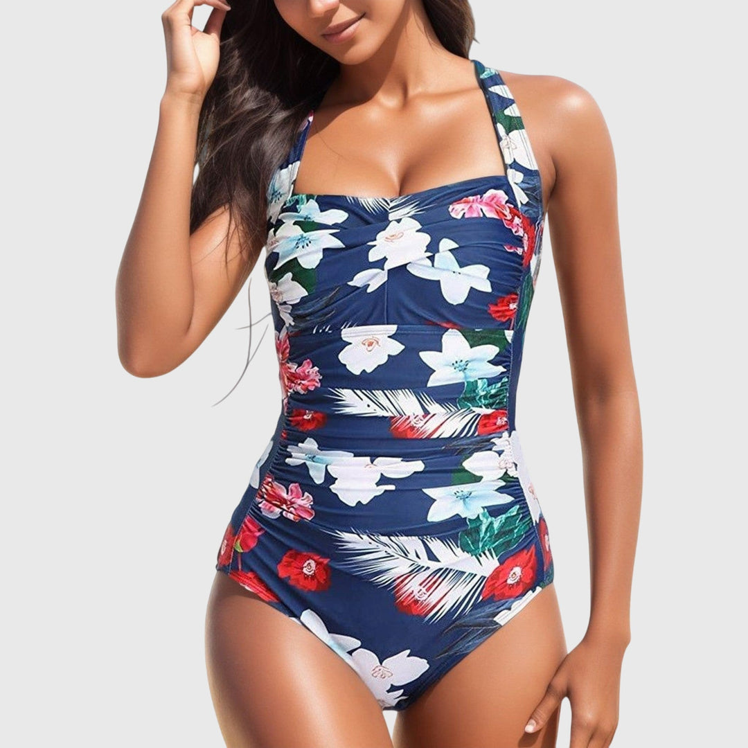 Maillot de bain femme une pièce à motif tropical vibrant, détails froncés, style col carré chic.