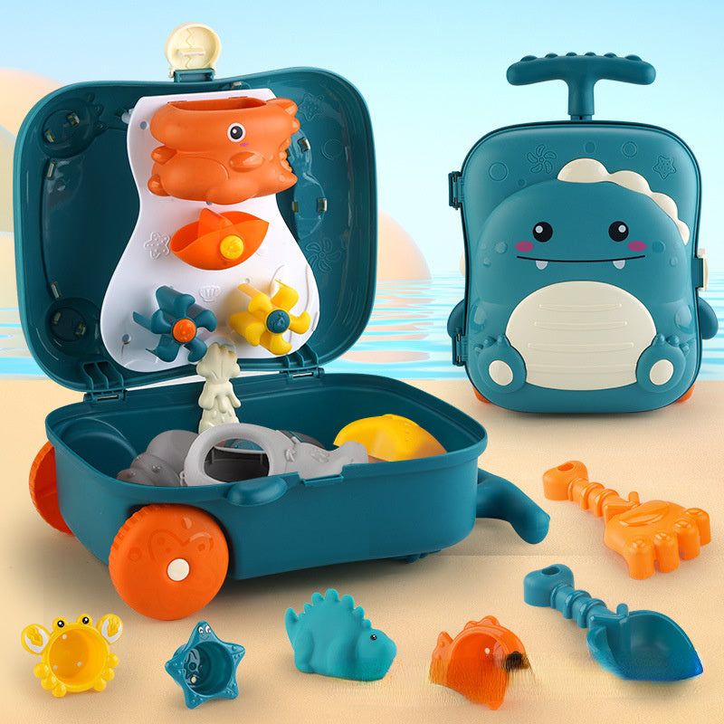 Valise portable baleine bleue remplie de jouets de plage et sable pour enfant.