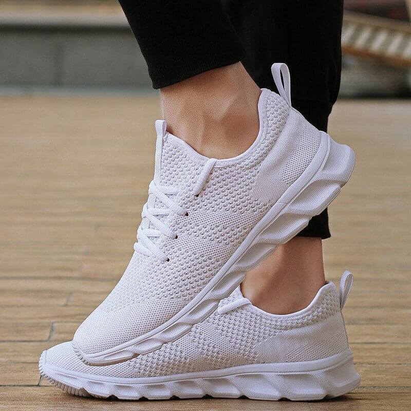 Chaussures athlétiques PureMotion blanches pour hommes, offrant confort et stabilité pour la marche.