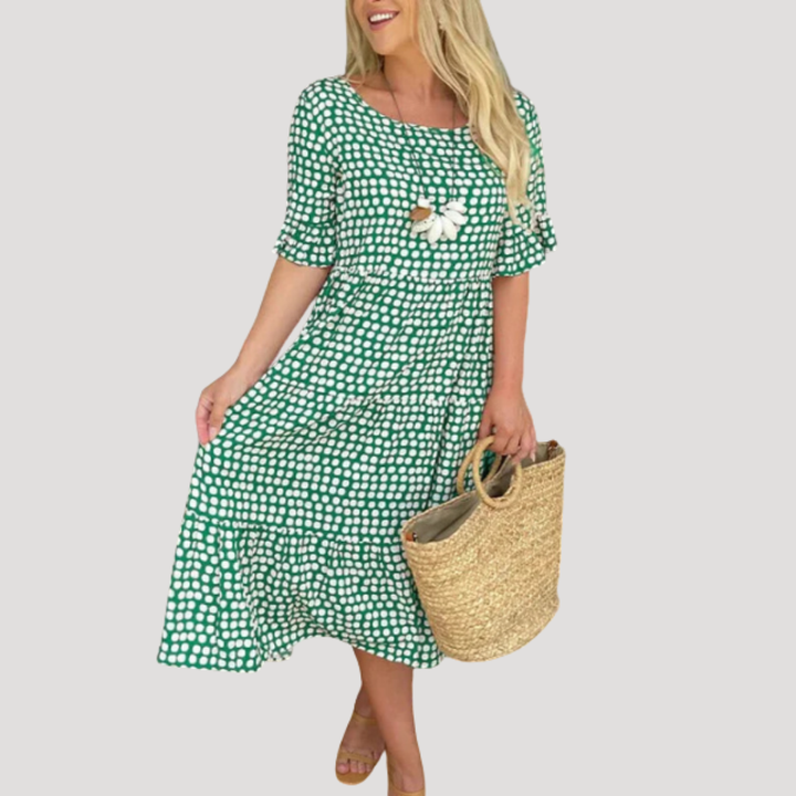 Robe midi élégante à pois, coupe fluide et manches courtes, parfaite pour un style décontracté chic femme.