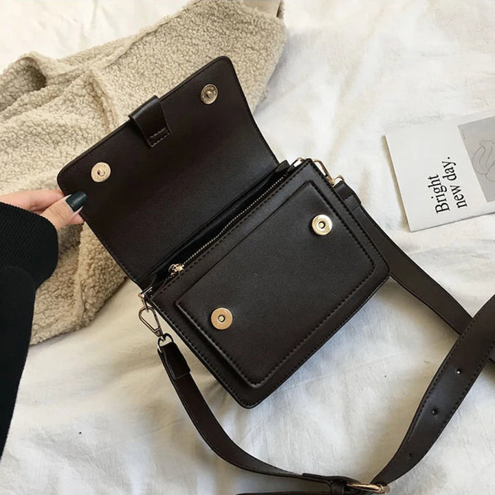 Sac à main femme noir, bandoulière ajustable, design chic. Accessoire élégant et pratique.