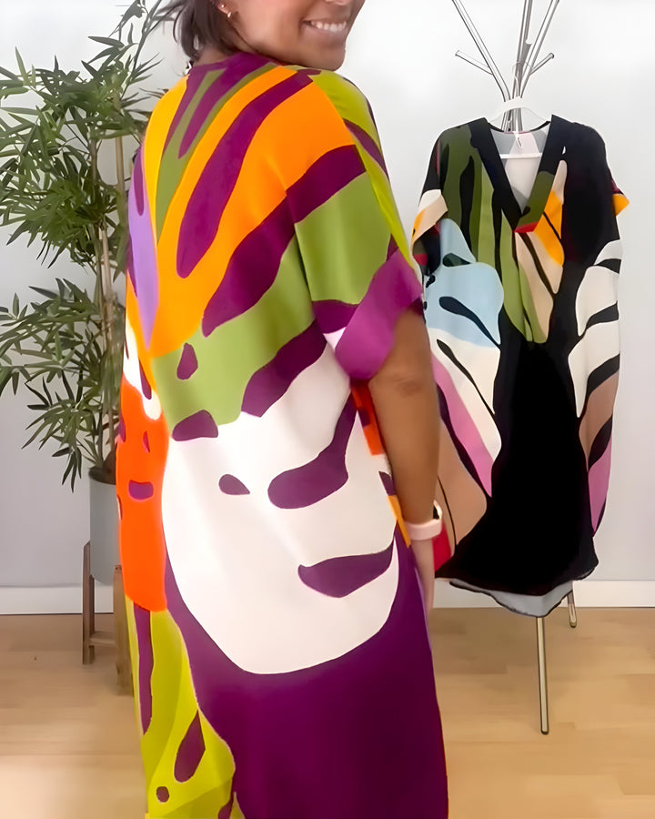 Robe midi fluide femme, imprimé feuillage exotique. Col V décontracté, parfaite pour les belles journées d'été.