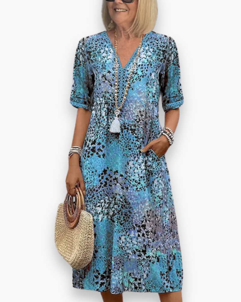 Robe midi fluide imprimée pour femme, alliant confort et élégance, parfaite pour le jour ou une soirée estivale.