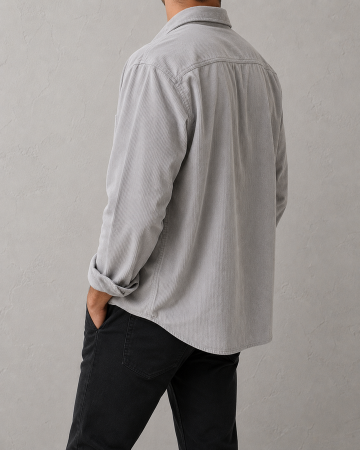 Détail d'une chemise homme boutonnée en velours côtelé marron. Coupe classique, idéale mode masculine.