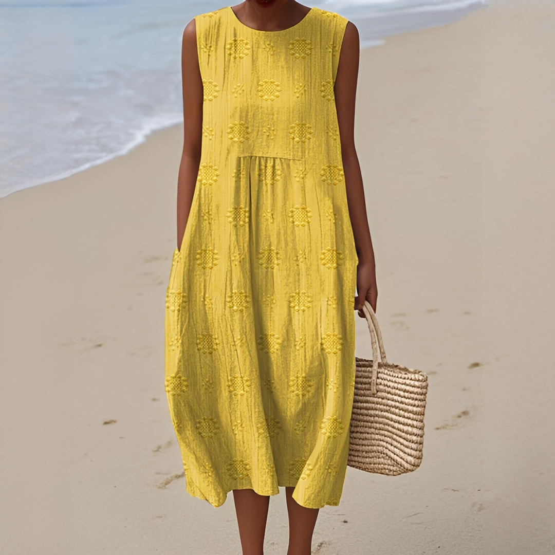 Robe d'été femme légère et fluide avec poches, coupe midi sans manches, parfaite pour la saison estivale.