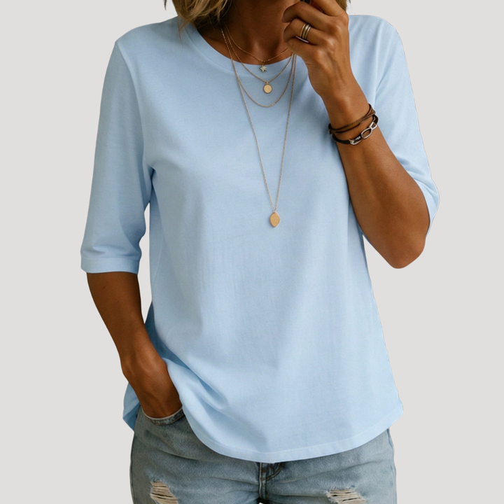 T-shirt femme mode été, col rond, manches 3/4. Confortable et élégant, un essentiel polyvalent pour la saison.