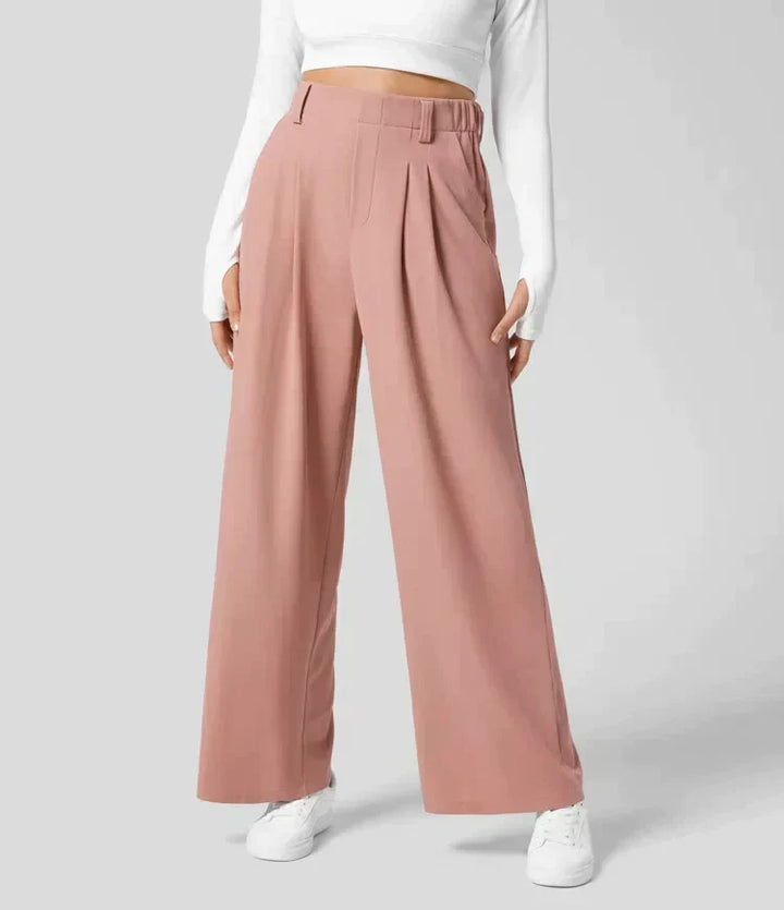 Pantalon large fluide rose clair pour femme, taille haute, confortable et élégant, idéal mode décontractée chic.