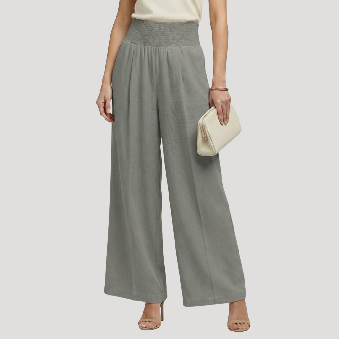 Pantalon femme fluide plissé à jambes larges, taille smockée pour une silhouette confortable et polyvalente.