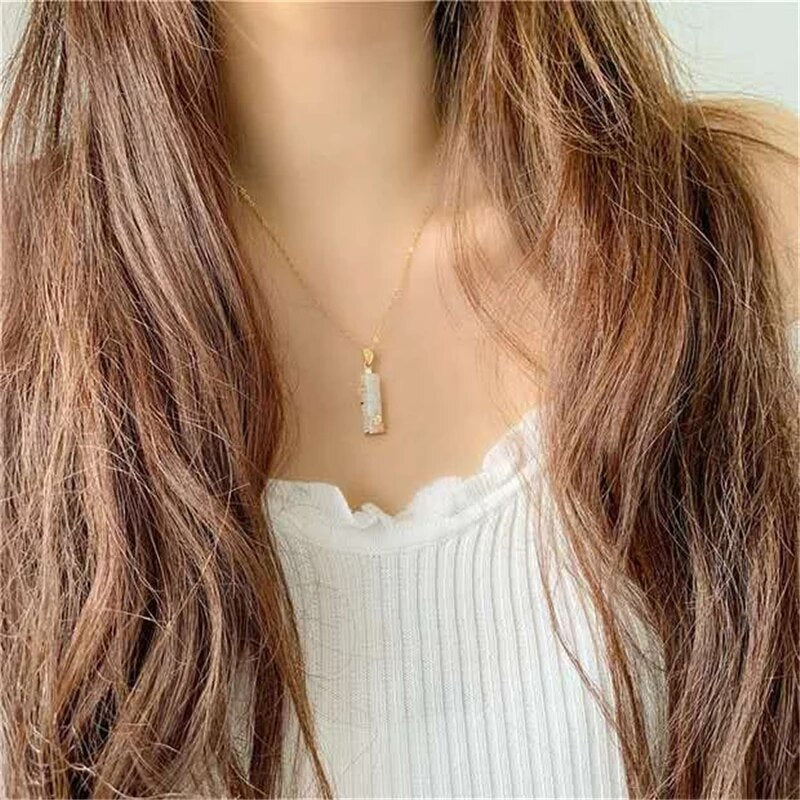 Collier amulette élégant pour femme, pendentif protection harmonie, vert et blanc. Bijou bien-être significatif.