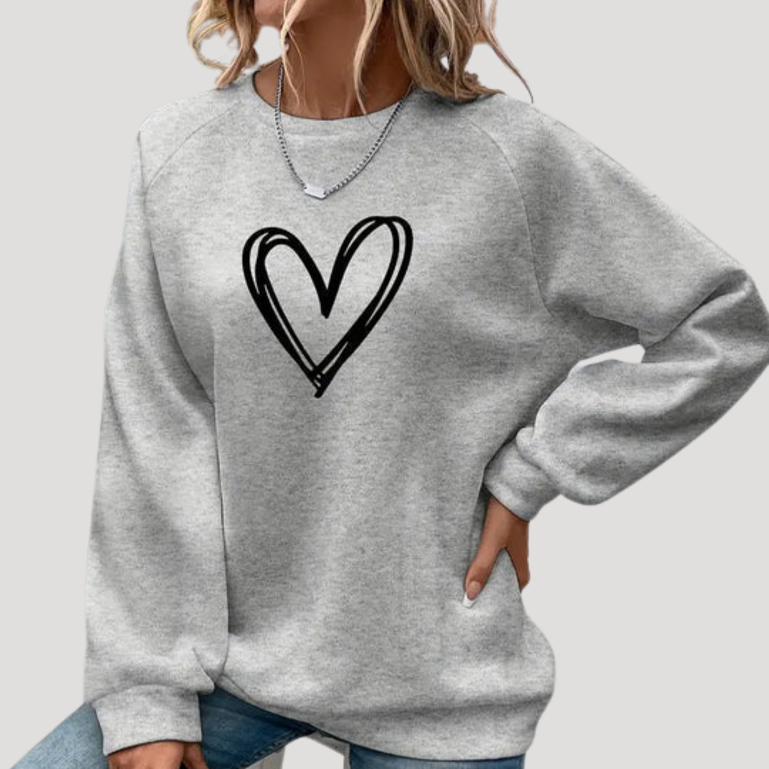 Pull femme confortable à col rond avec motif cœur, idéal pour la saison automne-hiver.