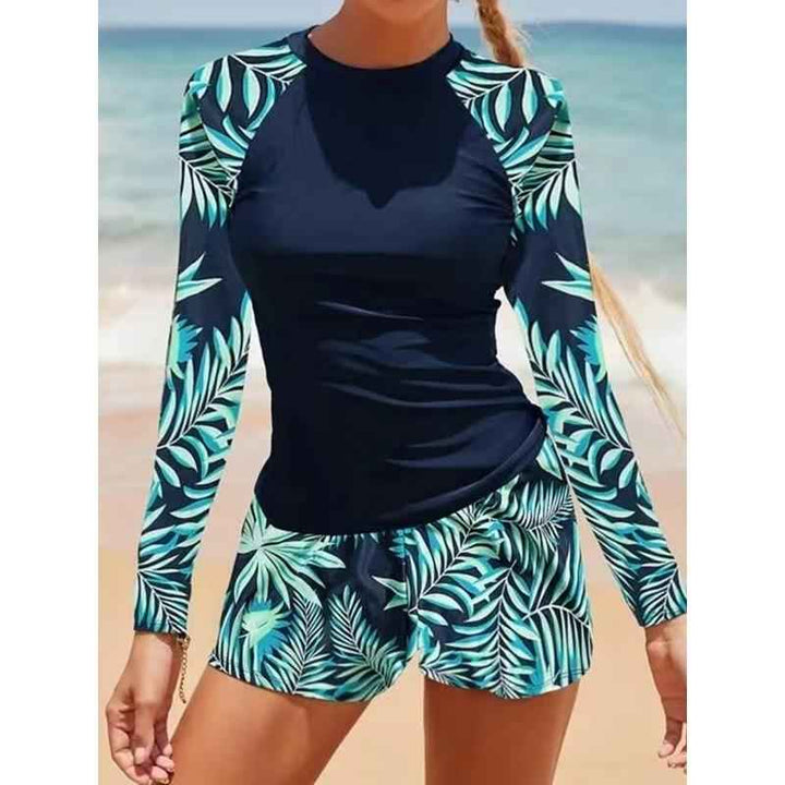 Maillot de bain femme noir, deux pièces, manches longues, idéal pour le sport et la protection solaire.