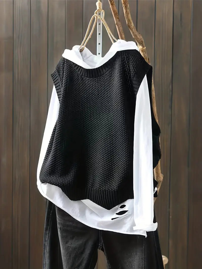 Pull femme sans manches noir, col rond. Chic et confortable pour une superposition élégante en toute occasion.