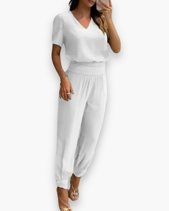 Combinaison femme élégante ajustée noire avec col-V, idéale pour soirée ou look professionnel chic.