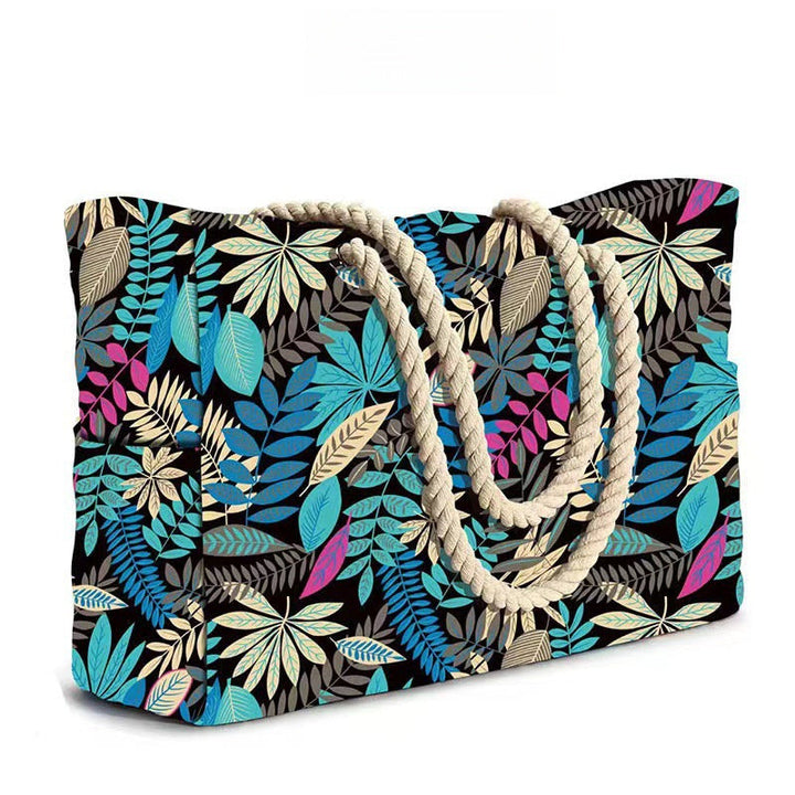 Sac de plage tendance, rayé bleu et blanc, avec poignées en corde.