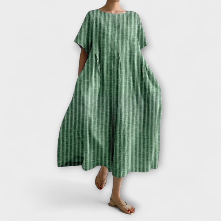 Femme portant une robe longue élégante à rayures, tenue décontractée parfaite pour le printemps et l'été.