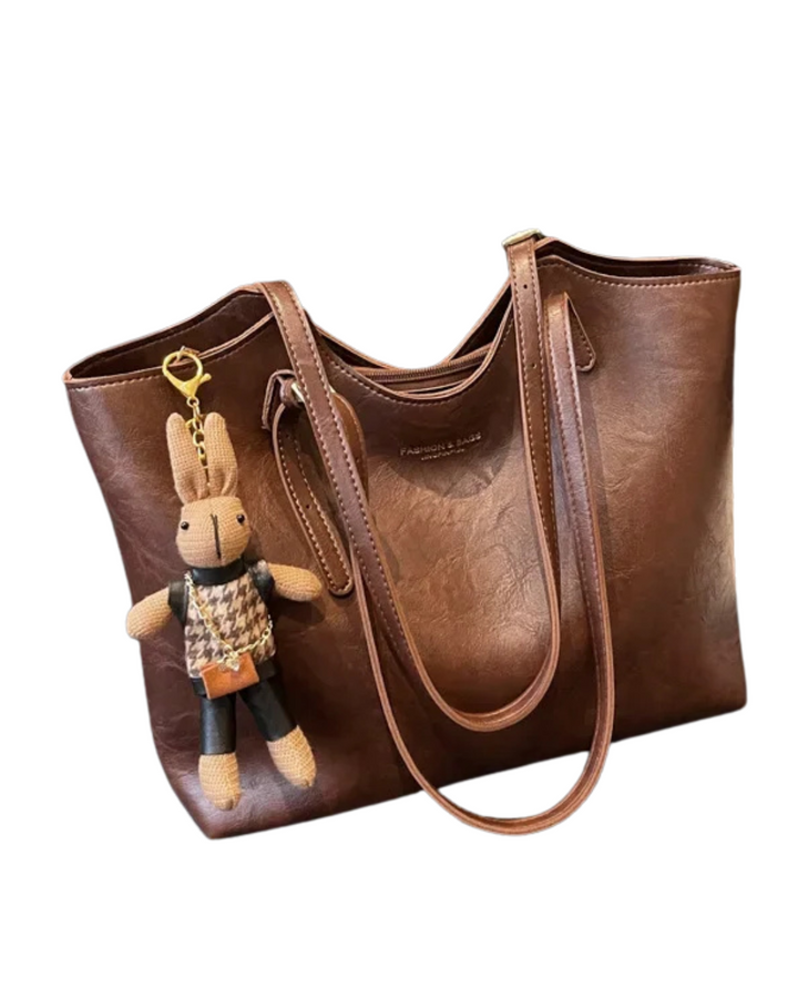 Sac fourre-tout vintage marron en cuir végan pour femme, style rétro élégant.