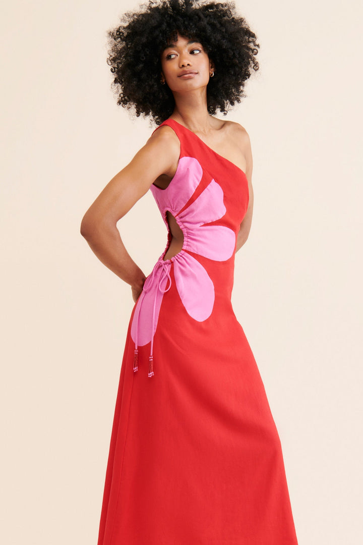 Femme élégante portant une robe longue florale asymétrique Serena, parfaite pour les soirées d'été.
