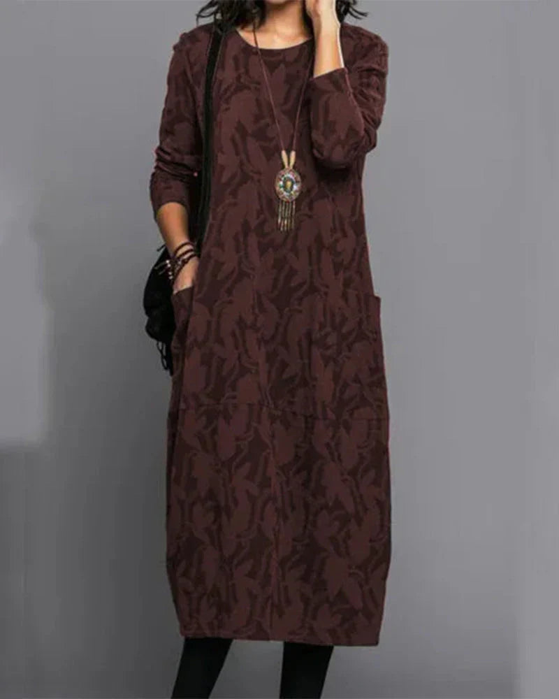 Robe fleurie longue avec manches, confortable et stylée pour femme. Poches pratiques incluses, parfaite au quotidien.