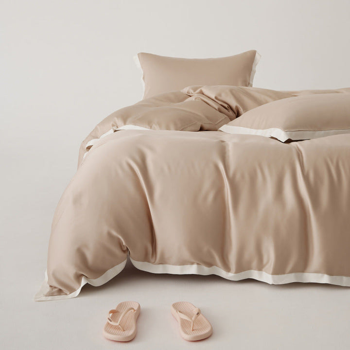 Détail patchwork sur housse de couette Tencel, ensemble de literie élégant et respirant pour confort moderne.