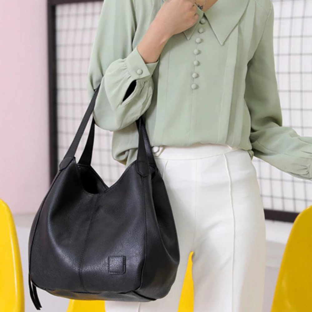 Sac à épaule polyvalent en cuir véritable, élégant pour travail et loisirs féminins.