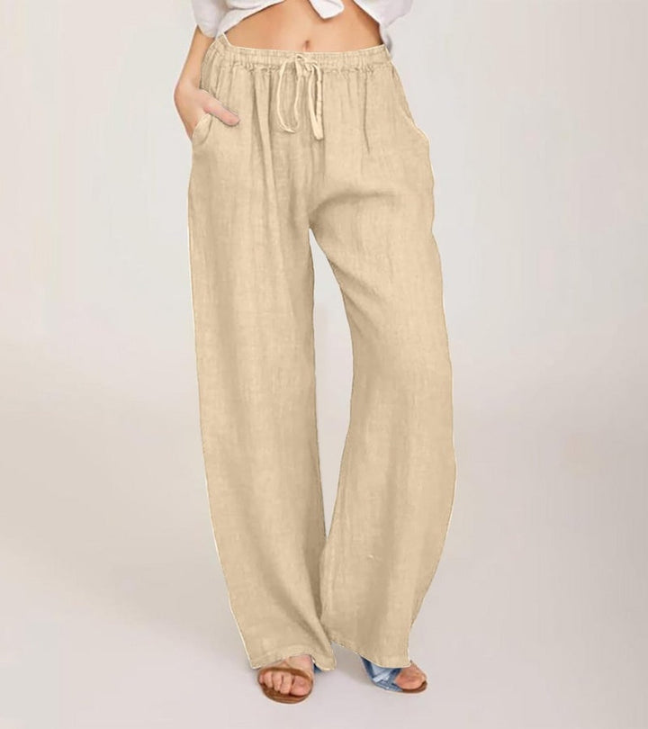 Silhouette femme élégante en pantalon large taille haute en lin, style décontracté estival moderne.