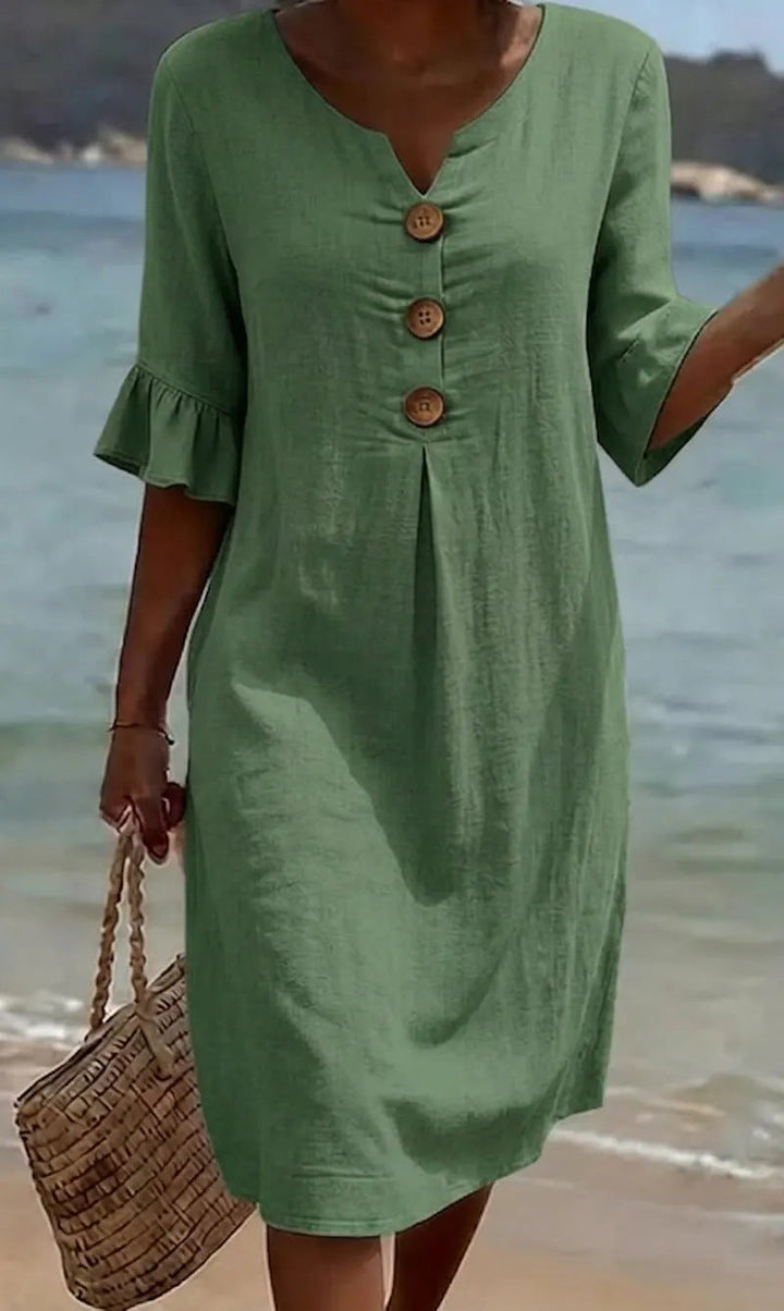 Robe de vacances femme en coton lin, boutonnée. Manches volantées, style léger et fluide pour l'été.
