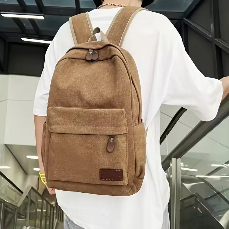 Sac à dos décontracté homme en canvas, robuste et tendance, parfait pour le quotidien et le voyage.