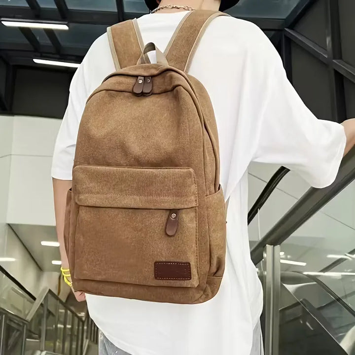 Sac à dos décontracté homme en canvas, robuste et tendance, parfait pour le quotidien et le voyage.