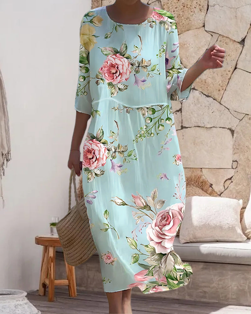 Femme portant une robe fleurie mi-longue élégante, idéale pour occasions spéciales ou quotidien printanier, mode féminine.