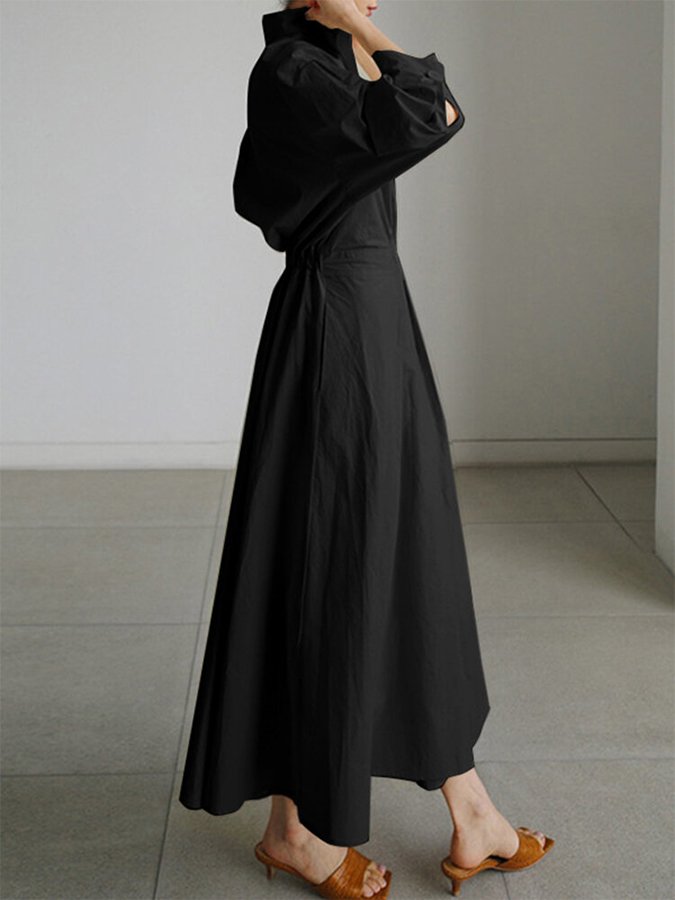 Femme élégante en robe midi boutonnée, style moderne. Parfaite pour le bureau ou une sortie, mode féminine.