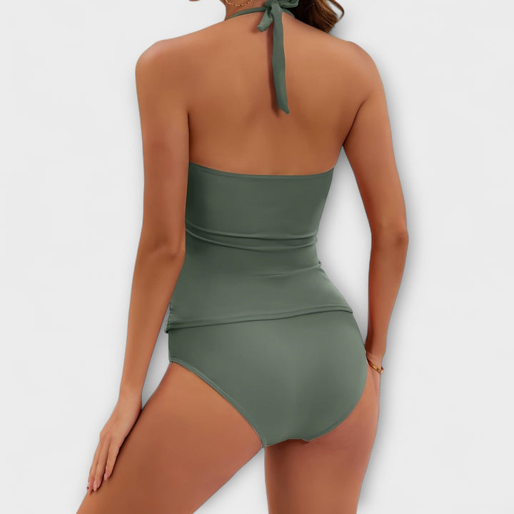Détail: Maillot de bain une pièce femme avec col V halter, fronces et ornements dorés.
